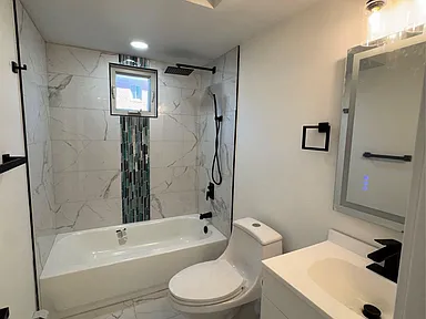 Fully renovated bathrooms with modern fixtures and tile